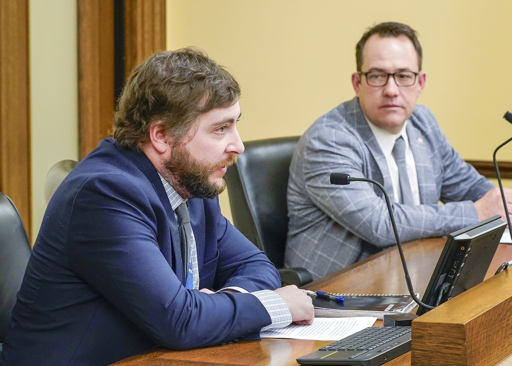 Sam Smith, government relations director for the Commerce Department, testifies before the House Energy Finance and Policy Committee March 4 during discussion of a bill sponsored by Rep. Chris Swedzinski, right, that would repeal the renewable development account. (Photo by Andrew VonBank)